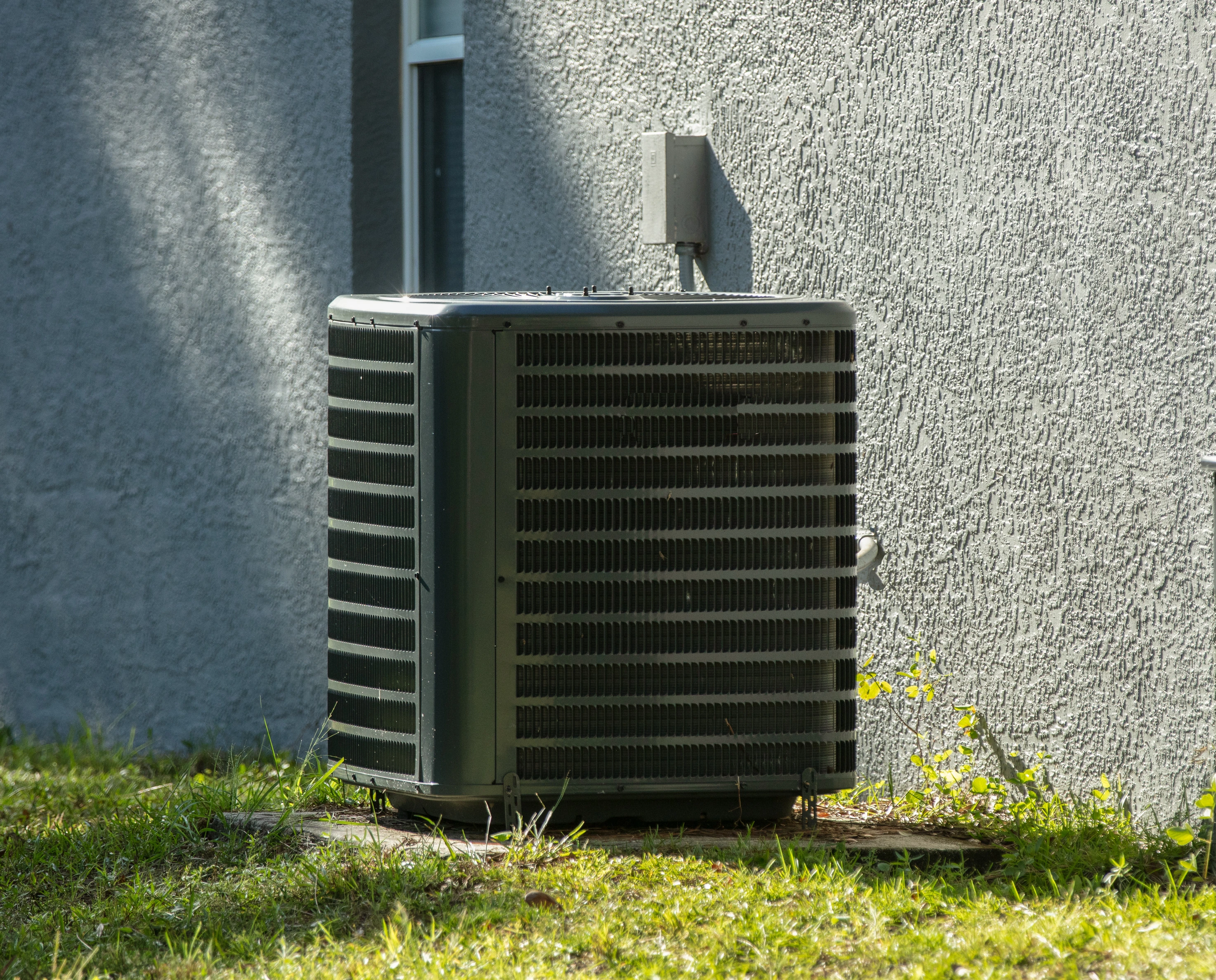 An outdoor HVAC unit in Milton, MA receiving professional services from Jarvis HVAC.