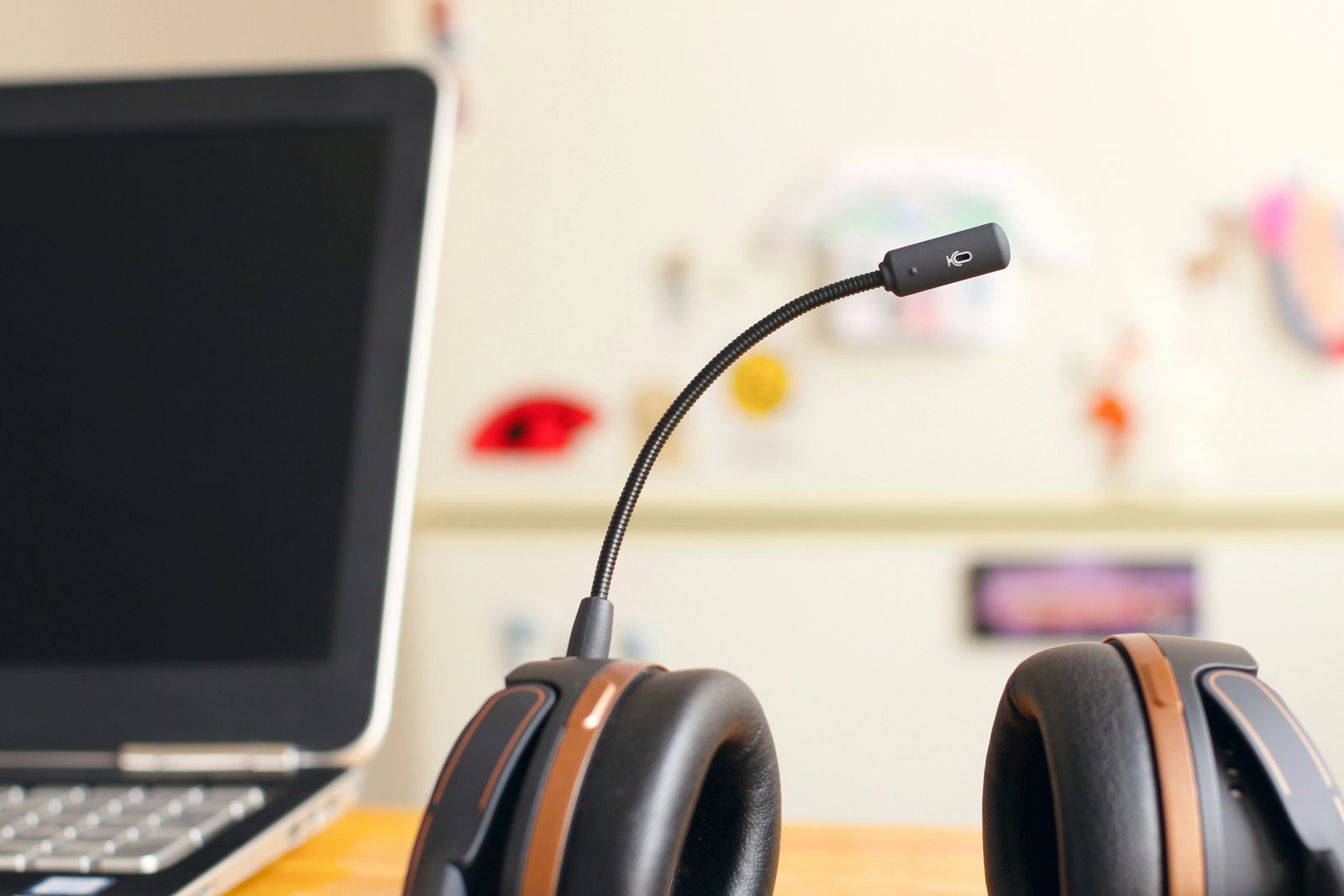 A headset with a microphone placed on a desk next to a laptop, symbolizing efficient customer service for scheduling HVAC services, including heating and cooling system installations.